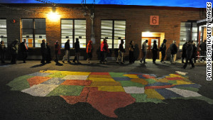 ALEXANDRIA, VA - NOVEMBER 06: People enter Washington Mill Elementary School to cast their vote in the U.S. presidential race, on November 6, 2012, in Alexandria, Virginia. Recent polls show that U.S. President Barack Obama and Republican presidential candidate Mitt Romney are in a tight race. (Photo by Patrick Smith/Getty Images)