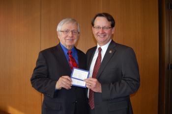 Representative Peters awarding local civil rights pioneer Reverend Richard Gleason with tickets to the Presidental Inauguration