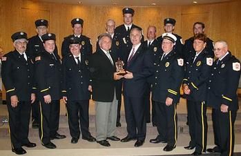 Green Tree Mayor Vince Abbato, and the borough's firefighters present Rep. Tim Murphy with a statue of a firefighter in appreciation of his work in securing federal funds for first responders.