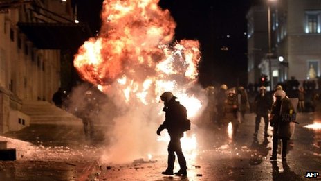 A petrol bomb explodes next to riot police in Athens. Photo: 7 November 2012