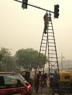 Workers paint traffic lights