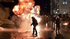 A petrol bomb explodes next to riot police in Athens. Photo: 7 November 2012