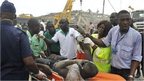 Rescue workers carry an injured man out from the debris of a collapsed building in Ghana's capital, Accra - Wednesday 7 November 2012