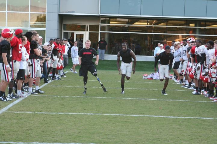 Photo: United States Marine Tony Mullis visited practice yesterday and showed the team what true determination is about.