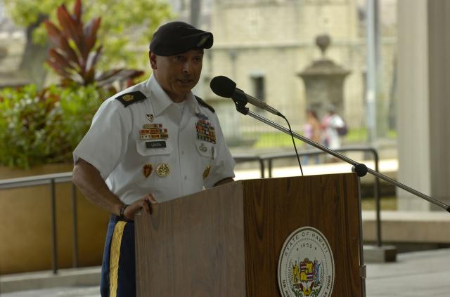 Command Sgt. Maj. Frank M. Leota, command sergeant major, 25th Infantry Division, speaks to an audience of friends, guests, and military leaders during a ceremony honoring the "Lost Heroes Art Quilt," a crafted work honoring the sacrifices of military service members from each of the Nation's 50 states at the Hawaii State Capitol Rotunda, Honolulu, July 21. The quilt, created by artist Judie Feingold, honors the sacrifice of fallen military service members of each of the Nation's 50 states with cutout photo portraits of the fallen heroes as children clad in "G.I. Joe" cloth jackets to represent the timeless spirit of the memory of their families. The quilt, currently on a nationwide tour, stops in Hawaii to honor the sacrifice of Hawaii's quilt representative, Pearl City, Hawaii native, Cpl. Kyle Kaeo Fernandez, who lost his life while serving with the division in Afghanistan in 2004.  (U.S. Army photo by Spc. Jesus J. Aranda, 25th Infantry Division Public Affairs Office)