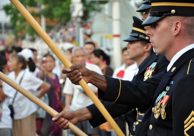 The division color guard stands at attention as the U.S. national colors are uncased before thousands of onlookers at the 2010 World Expo in Shanghai, China. The color guard consisted of Soldiers from various staffs throughout the Division. The color guard members included SFC Michael Barthen (front), SGT Nathan Cassidy, SFC Jovan Velasquez and SFC Kimberly King. The division color guard and band are the first U.S. military unit to perform in the World Expo and the first cultural exchange unit in China this year. The division color guard and band are in China on an international community relations mission representing the U.S. Army and Pacific Command.