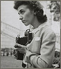 Arlington Cemetery, Arlington, Virginia. A girl taking a picture of the ceremony of laying a wreath on the Tomb of the Unknown Soldier (LOC) by The Library of Congress