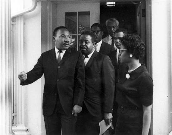 Martin Luther King, Jr. leaves the West Wing after meeting with President Johnson