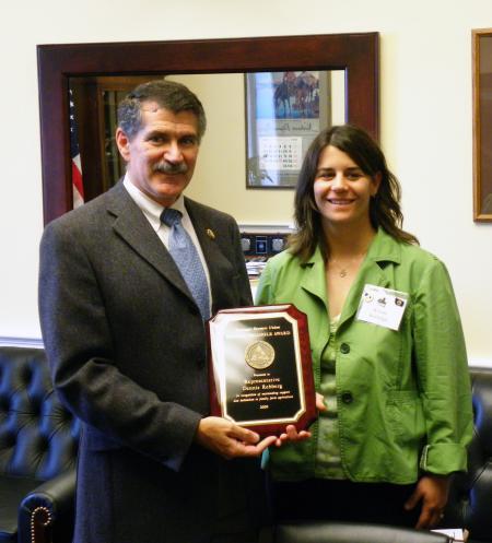 Congressman Denny Rehberg is presented with The Golden Triangle Award by Montana Farmers Union member Kristie Rutledge in his Washington, D.C. Office.