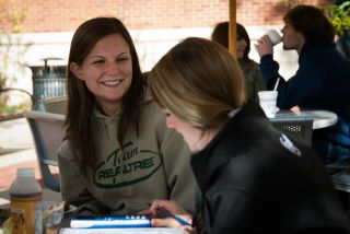 Photo: Kylie Kiess (junior, animal sciences), left, eats lunch outside of the Creamery while classmate Hannah Grim completes lab homework before their class in animal products technology on Wednesday, October 17, 2012.