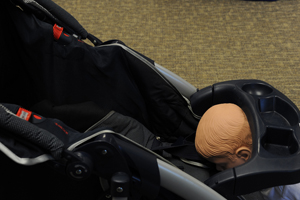 Baby trapped between the tray and seat of a stroller