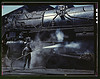 Mrs. Viola Sievers, one of the wipers at the roundhouse giving a giant "H" class locomotive a bath of live steam, Clinton, Iowa. Mrs. Sievers is the sole support of her mother and has a son-in-law in the Army (LOC) by The Library of Congress