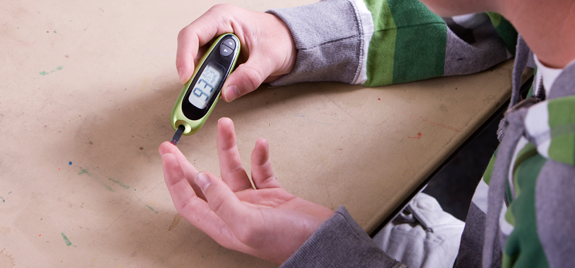 Young man looking at a glucose meter