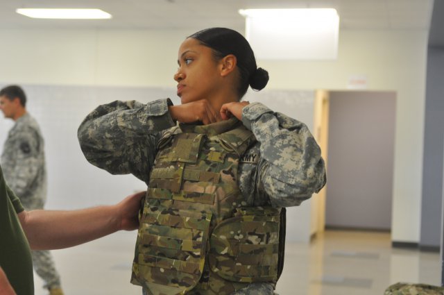 Spc. Gilliann Campbell, a Female Engagement team Soldier with 1st Brigade Combat Team, 101st Airborne Division (Air Assault), adjusts the collar of her Generation III Improved Outer Tactical Vest, Aug. 21, 2012, at Fort Campbell, Ky. Campbell is one of 19 female Soldiers from the 101st to participate in the fielding of this vest designed specifically for the needs of Army women. Campbell said it was already easier to pick up items off the ground in the shorter and less bulky vest.