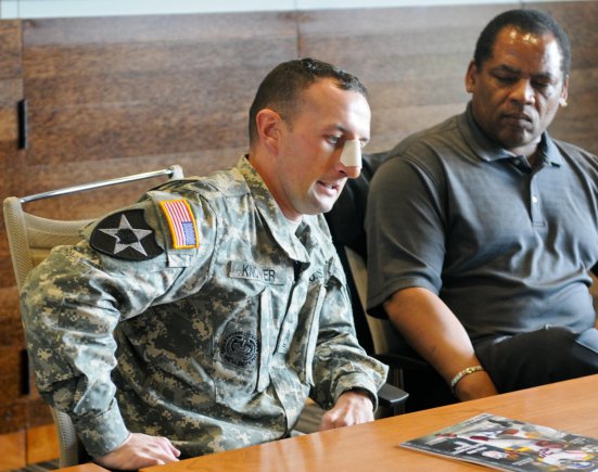 Sgt. 1st Class James Knower, a platoon sergeant with 2nd Stryker Brigade Combat Team, 2nd Infantry Division, sits next to former NFL player
Michael Jackson, as he talks about his experience in Afghanistan. Knower, along with other Soldiers, NFL players and leaders, took part in a discussion about traumatic brain injury at Virginia Mason Athletic Center in Seattle, Nov. 20, 2012.