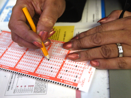 A lottery player selects her numbers on a Powerball ticket. (credit: Tim Boyle/Getty Images)