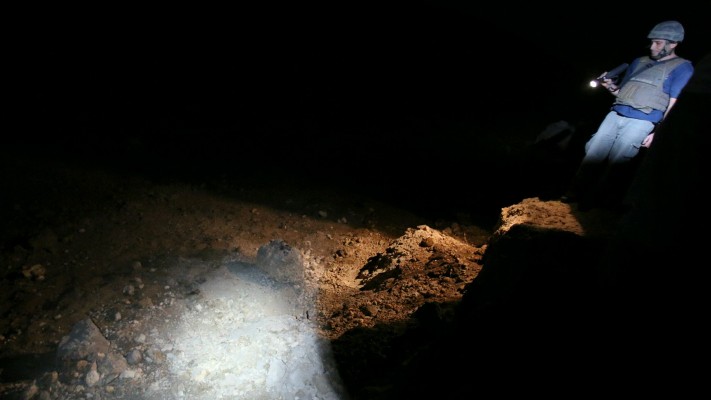 Explosives experts examine the site where a rocket fired from the Gaza Strip landed in Gush Etzion on Friday. (photo credit: Oren Nahshon/Flash90)