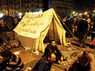 Pro-democracy demonstrators occupy Cairo's Tahrir Square on Friday night. The writing on the tent reads, "Egypt is not a farm, Constitution party, Egypt for Egyptians."