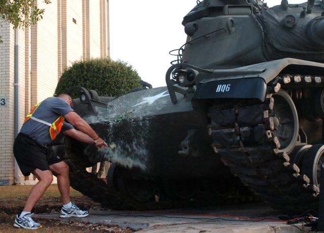 FORT HOOD, Texas- Col. John Peeler, commander of the 2nd Brigade Combat Team, 1st Cavalry Division, christens the 2nd BCT\'s M60 Patton tank with a bottle of Irish whiskey in front of the 2nd BCT headquarters building, here, Aug. 30. The christening, part of the brigade's birthday celebration, marked 93 years of the "Black Jack" brigade.