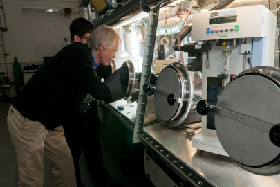 Argonne scientists Ira Bloom (front) and Javier Bareño prepare a sample of battery materials for Raman spectroscopy, which is used to gather information regarding the nature of the materials present in the sample. | Photo courtesy of Argonne National Laboratory.