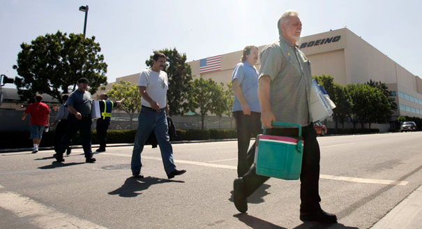 Workers leave the Boeing Co. plant where the C-17 military cargo plane is produced, in Long Beach, Calif. | AP Photo