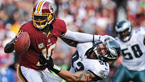 Quarterback Robert Griffin III of the Washington Redskins stiff arms defensive end Jason Babin of the Philadelphia Eagles in the second quarter at FedEx Field in Landover, Maryland