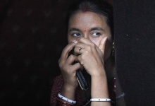 A sex worker watches a Raksha Bandhan festival celebration in a red light area in Mumbai August 23, 2010.  REUTERS/Danish Siddiqui