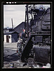 Women wipers of the Chicago and North Western Railroad cleaning one of the giant "H" class locomotives, Clinton, Iowa. Mrs. Marcella Hart and Mrs. Viola Sievers (LOC) by The Library of Congress