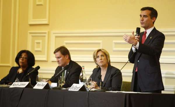 Los Angeles mayoral candidates Jan Perry, left, Kevin James and Wendy Greuel listen to Eric Garcetti during the candidates debate in Hollywood on Sept. 19.