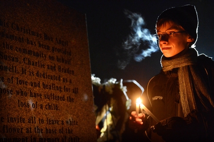 Tyler Troyer, 14, of Tacoma looks Thursday at the inscription on a new memorial to children at Woodbine Cemetery in Puyallup. (LUI KIT WONG/Staff photographer)