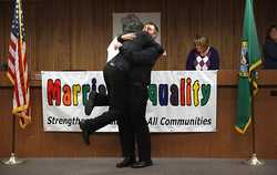 Rory Smallwood leaps into the arms of his partner, Joey Summerson, after the pair received their marriage license during ceremonies at the Thurston County Courthouse shortly after midnight on Wednesday, Dec. 6, 2012. (TONY OVERMAN/Staff photographer) (Tony Overman/The Olympian)