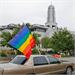 File photo of a rainbow flag in front of a Mormon church (© George Frey/Getty Images)