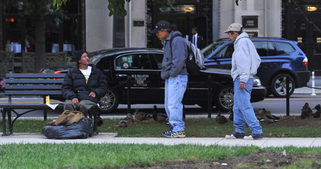 A group of homeless men in a park