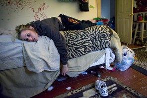 Tabitha Rouzzo lies on her bed after being grounded by her mother in New Castle, Penn.