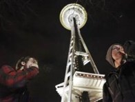 People light up near the Space Needle after the law legalizing the recreational use of marijuana went into effect in Seattle, Washington. (Photo: REUTERS/Cliff Despeaux)