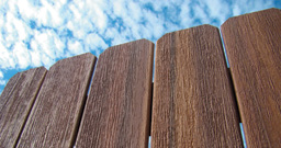 Closeup of stained dog-ear wood fencing