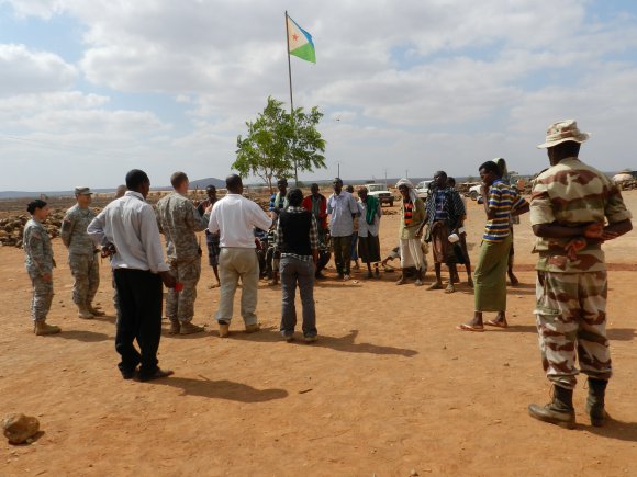 409th Contracting Support Brigade contracting officers in support of the Combined Joint Task Force "Horn of Africa, along with team members of the 490th Civil Affairs team, conduct a hiring action in Djibouti, Dijbouti. U.S. Navy Seabees are building a new health clinic in this remote village.