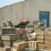 Soldiers inspect crates filled with sub-munitions and fuzes