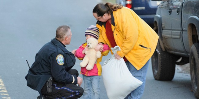 A child and her mother leave staging area outside Sandy Hook Elementary School in Newtown, CT. A gunman opened fire inside school killing 27 people, including 18 children. (Photo by James Keivom/NY Daily News via Getty Images)