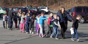 In this photo provided by the Newtown Bee, Connecticut State Police lead children from the Sandy Hook Elementary School in Newtown, Conn., following a reported shooting there Friday, Dec. 14, 2012. Photo: Shannon Hicks / Newton Bee / AP