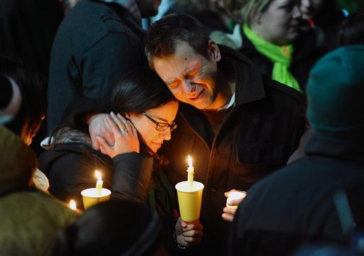 Ted Kowalczuk, of Milford, Conn., and his friend Rachel Schiavone, of Norwalk, Conn., attend a candlelight vigil held behind Stratford High School on the Town Hall Green in Stratford, Conn. on Saturday December 15, 2012. Kowalczuk and Schiavone were close friends to Stratford High graduate Vicki Soto, who was killed in yesterday's mass shooting at Sandy Hook Elementary School in Newtown. Soto was a teacher at the school.(AP Photo/The Connecticut Post, Christian Abraham) MANDATORY CREDIT