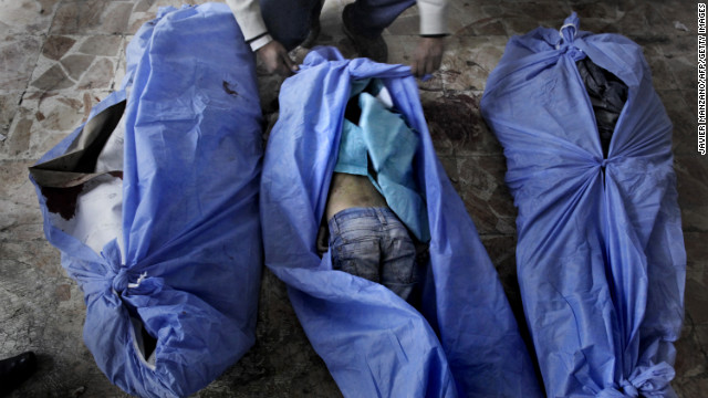 The bodies of three children reportedly killed in a mortar shell attack are laid out for relatives to identify at a makeshift hospital in Aleppo on December 2. 