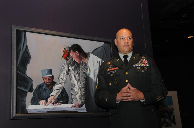 Master Sgt. Martin Cervantez stands in front of his painting, "A Huge Responsibility." Cervantez is the artist-in-residence at the Center of Military History at Fort McNair in Washington, D.C.