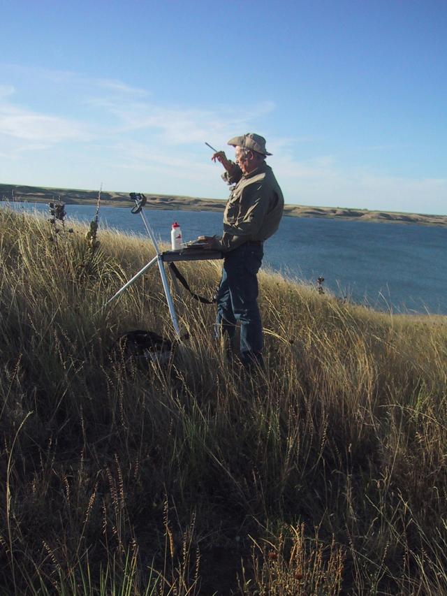 Jim Pollock, a former combat artist, paints a landscape in plein-air in this recent photo.