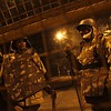 Policemen stand guard on a road to stop demonstrators from moving towards the India Gate in New Delhi December 24, 2012. Indian authorities throttled movement in the heart of the capital on Monday, shutting roads and railway stations in a bid to restore law and order after police fought...