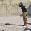 A boy scout salutes near the graves of victims of a suicide bomb attack during a memorial service at St. Theresa's Church in Madalla, on the outskirts of Nigeria's capital Abuja, December 23, 2012. Boko Haram has killed hundreds in its campaign to impose sharia law in northern Nigeria...