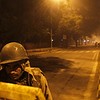 A policeman stands guard on a road to stop demonstrators from moving towards the India Gate in New Delhi December 24, 2012. Indian authorities throttled movement in the heart of the capital on Monday, shutting roads and railway stations in a bid to restore law and order after police...