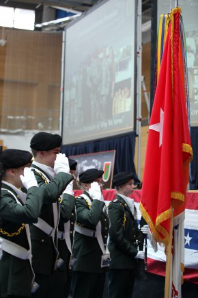 LUCIUS D. CLAY KASERNE, WIESBADEN, Germany (November 16, 2012) " The Wiesbaden High School Junior Reserve Officer Training Corps color guard salute the U.S. flag while the National Anthem is played during the 5th Signal Command Operation Solemn Promise annual commemoration ceremony in the Lucius D. Clay Kaserne Fitness Center. More than 2,000 Soldiers, Civilians, Local Nationals and Family Members gathered in the fitness center and through video teleconference to during the event. This year's commemoration ceremony officially began 5th Signal Command's Army Profession campaign.  Throughout 2013 5th Signal Command will hold several events that highlight on the five essential attributes of the Army Profession - Trust, Military Expertise, Esprit de Corps, Honorable Service, Stewardship of the Profession.