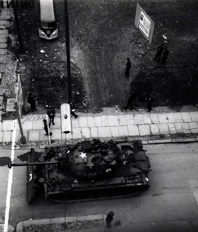 A U.S. tank crew stands guard at Checkpoint Charlie in West Berlin in 1961 during one of several standoffs between U.S. personnel and East German police that year. The sign in the upper right of the photo bears the famous remark made by Walter Ulbricht, General Secretary of the Socialist Unity Party of Germany on June 15, 1961: "Niemand hat die Absicht, eine Mauer zu errichten" -- "Nobody has any intention of building a wall. Two months later construction on the Berlin Wall began.