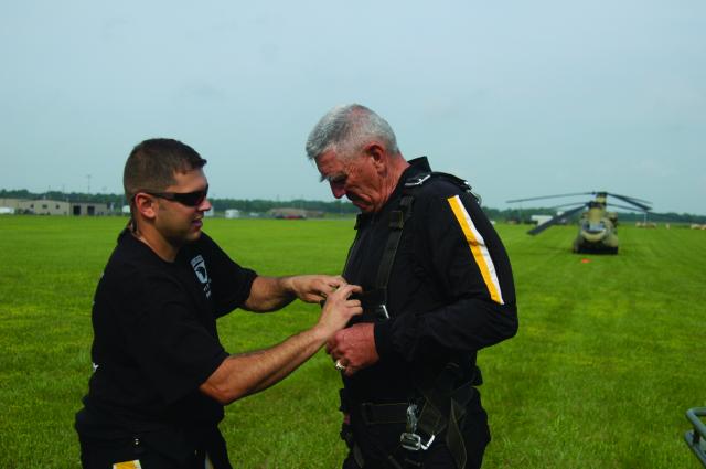 Sgt. 1st Class Larry Jarrett, 101st Airborne Division Parachute Demonstration Team, prepares R. Lee Ermey for a tandem jump out of a CH-47F Chinook helicopter. Ermey, best known for his role as a drill instructor in "Full Metal Jacket" and host of "Mail Call" was at Fort Campbell to film an episode of his new show "Lock and Load."